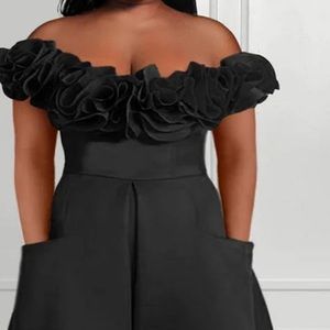 NEW never been worn jumpsuit with off the shoulder flowers.